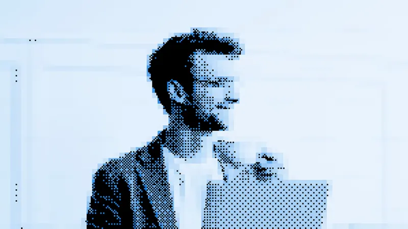 Freelance designer working at their desk on a laptop and external display